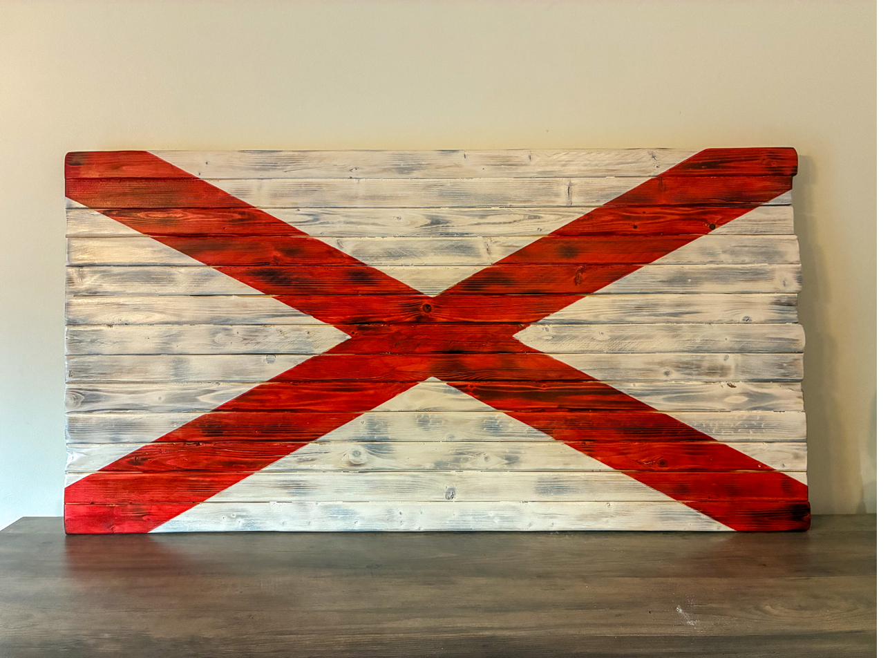 Handmade wood Alabama state flag with a bold red cross of Saint Andrew on whitewashed pine boards